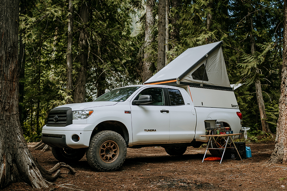 5-01-toyota-tundra-overland-camping-woods-lifted-truck-camper-GFC-desk-to-glory