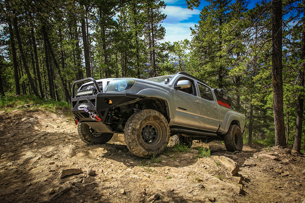 5-01-silver-2nd-Gen-Toyota-Tacoma-forest-trail-rocks
