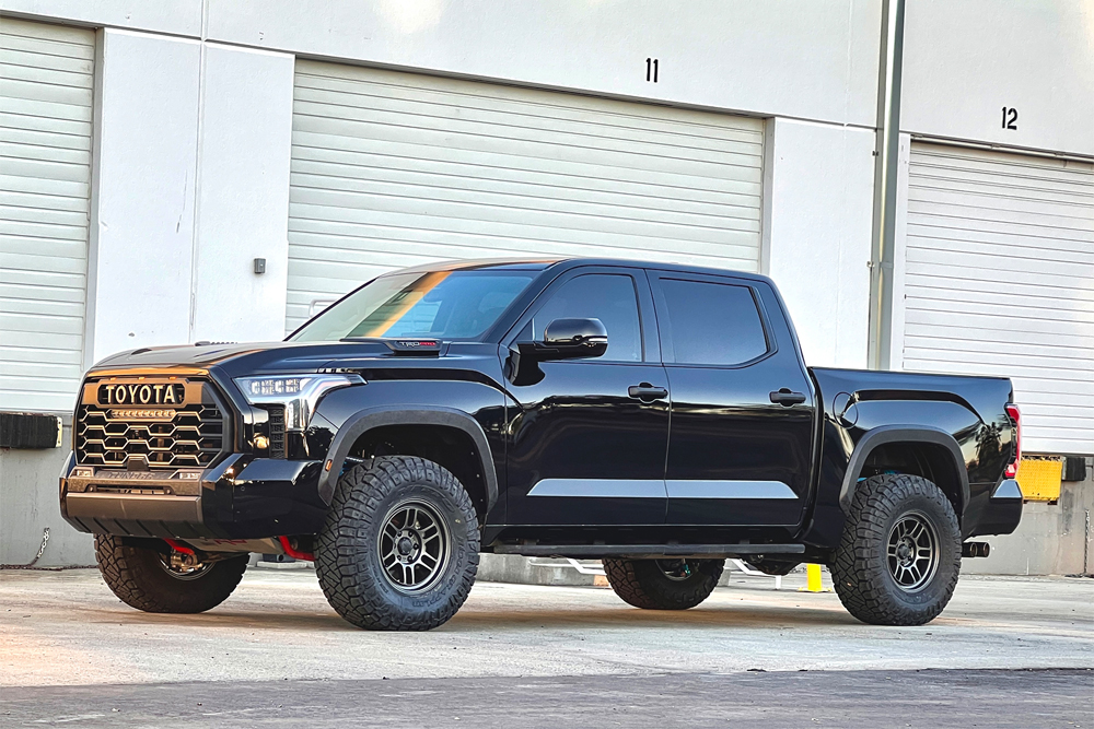 12-black-2022-toyota-tundra-lifted-total-chaos-king-shocks-front-angle-web